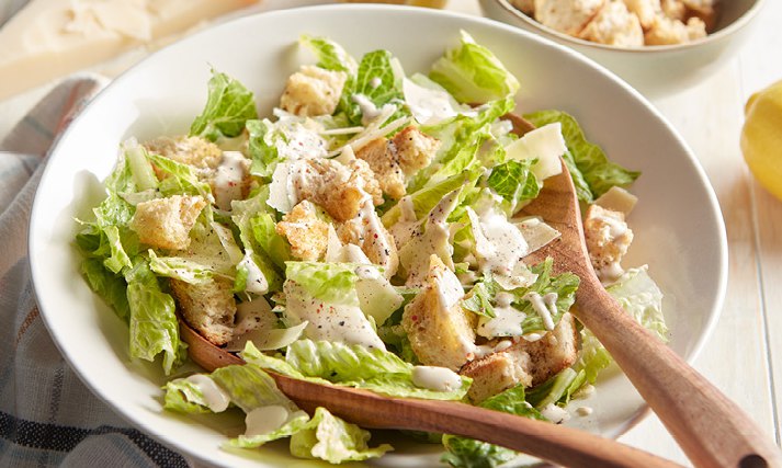 Spot the signature tableside classic: crisp romaine wrapped in a rich, garlicky dressing. How do we label this legendary plate?