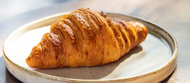 Which crescent-shaped classic defines the ultimate Parisian morning?