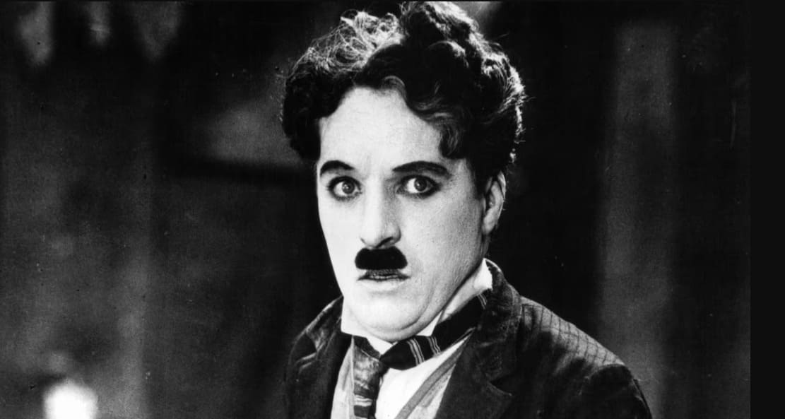 This legendary Londoner, born in 1889, captured the world's imagination with his signature look featuring a bowler hat, a cane, and the beloved persona known as the Tramp. Who is this cinematic icon?