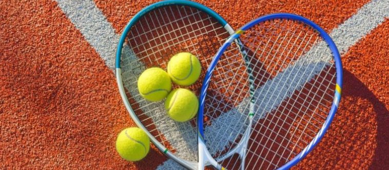 Picture a classic court setup featuring a vibrant, felt-covered yellow sphere, a precision-strung frame, and a taut center barrier. Which discipline are we styling here?
