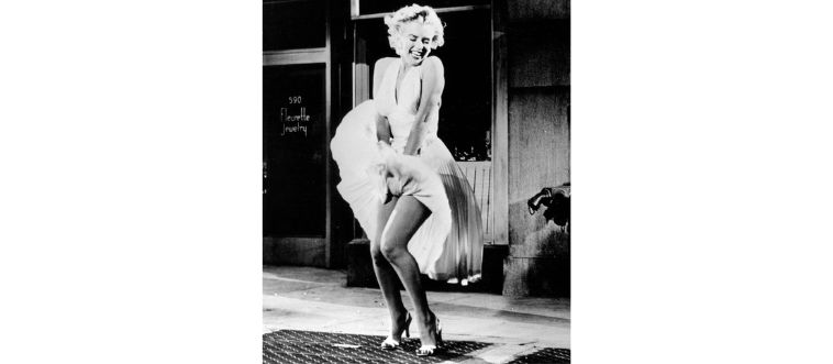 That unforgettable moment with the white pleated dress billowing over a subway grate—who made this breezy silhouette immortal?