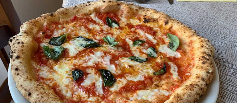This flatbread masterpiece has become the ultimate global signature. Where did this iconic cheese-and-tomato staple first find its fashion-forward form?